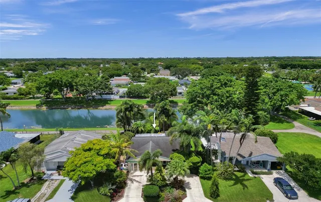 an aerial view of a house with a garden and lake view