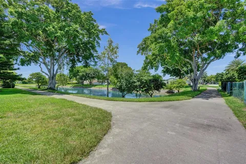 an aerial view of residential houses with outdoor space and lake view