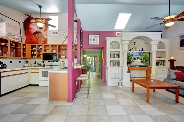 a living room with furniture a ceiling fan and a window