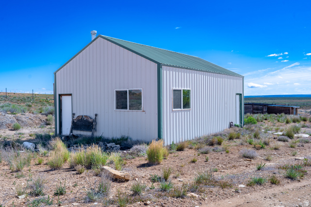 700 East Peter Springs Road Monticello, UT 84535 - Photo 42 of 57 Metal-clad structure with a green pitched roof