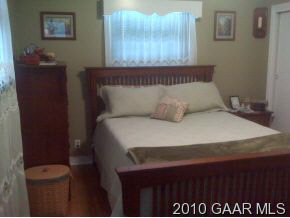 3610 Rockfish Road Grottoes, VA 24441 - Photo 4 of 9 a bedroom with a bed and a night stand