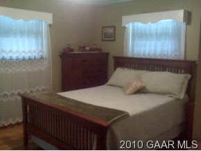 3610 Rockfish Road Grottoes, VA 24441 - Photo 7 of 9 a bed sitting in a bedroom next to a cabinet