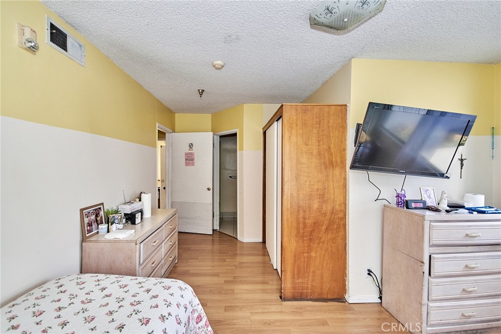 528 Howard Street Alhambra, CA 91801 - Photo 21 of 37 a bedroom with a bed and wooden floor