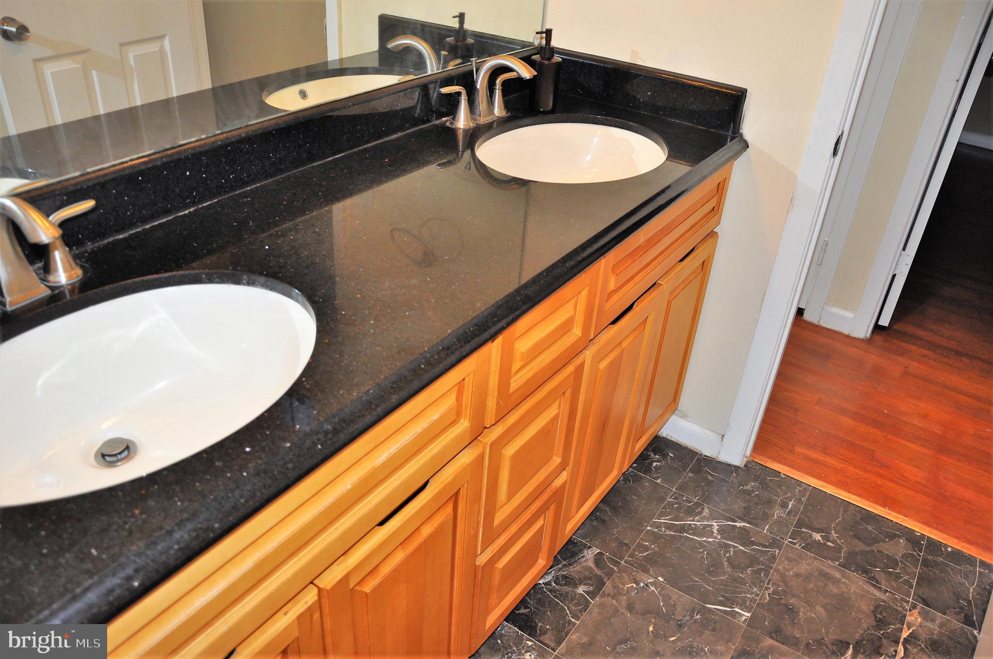 705 Crosby Road Baltimore, MD 21228 - Photo 16 of 37 a bathroom with a sink and a mirror