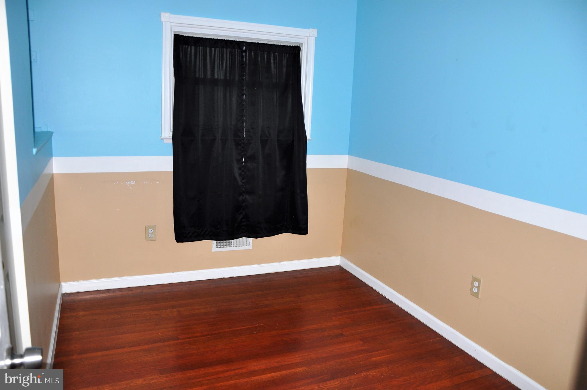 705 Crosby Road Baltimore, MD 21228 - Photo 20 of 37 a view of an empty room with wooden floor