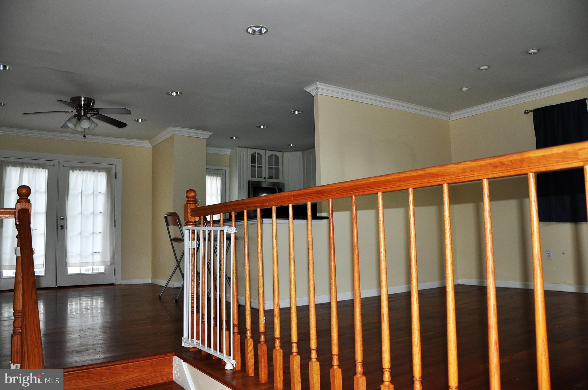 705 Crosby Road Baltimore, MD 21228 - Photo 26 of 37 a view of a hallway with wooden floor and staircase