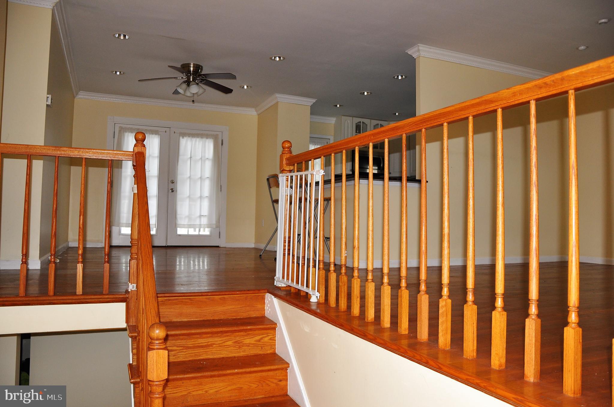 705 Crosby Road Baltimore, MD 21228 - Photo 28 of 37 a view of staircase with wooden floor and fan