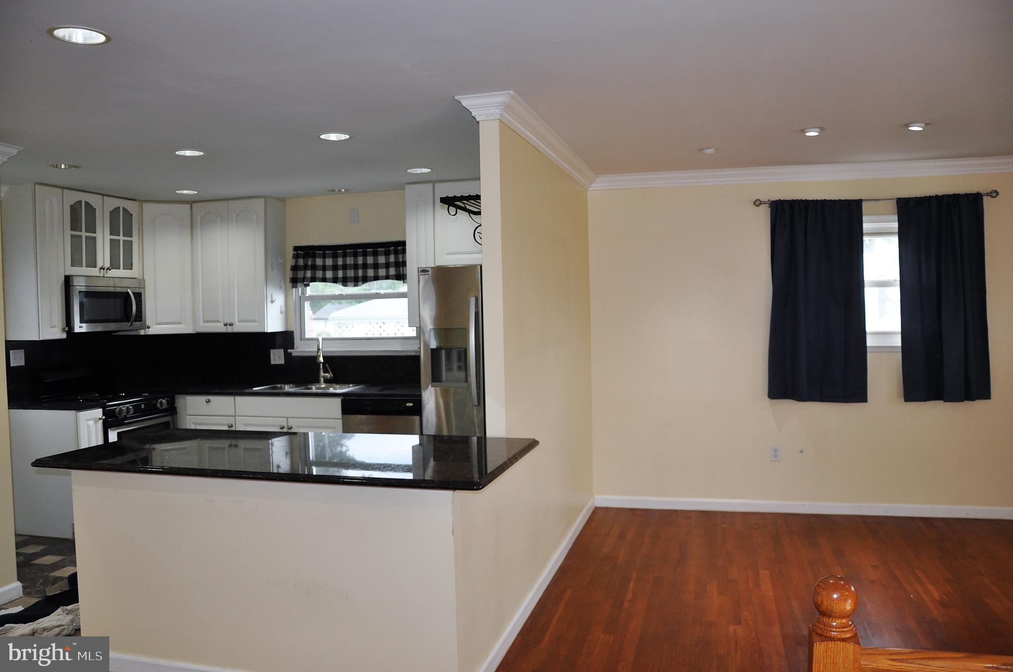 705 Crosby Road Baltimore, MD 21228 - Photo 9 of 37 a kitchen with stainless steel appliances granite countertop a stove and a refrigerator