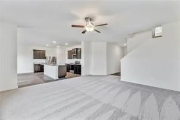 a view of a kitchen with a sink and a ceiling fan