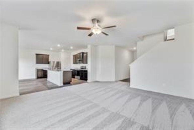 14101 Prospector Way Elgin, TX 78621 - Photo 3 of 9 a view of a kitchen with a sink and a ceiling fan
