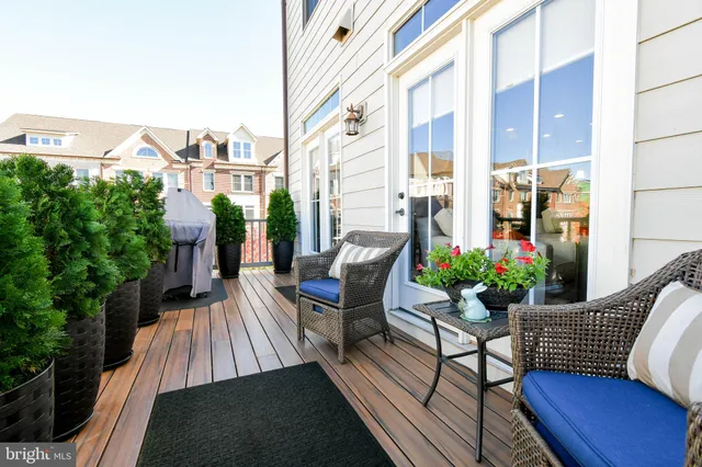 a view of balcony with chairs potted plants with wooden floor