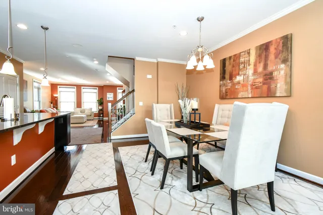 a dining room with furniture a chandelier and wooden floor