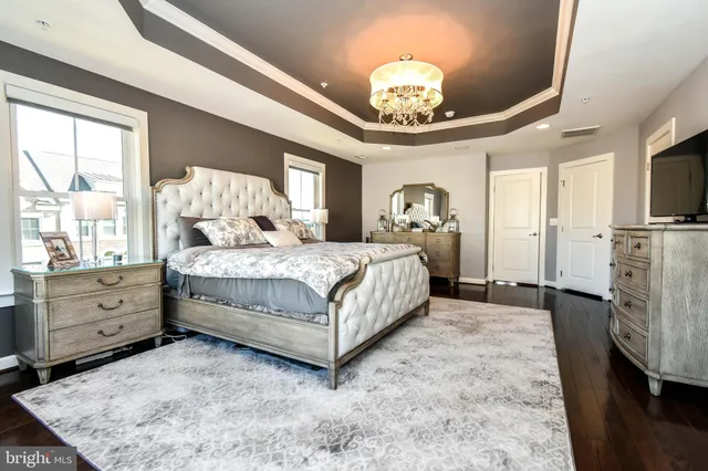 a bedroom with a bed and a chandelier