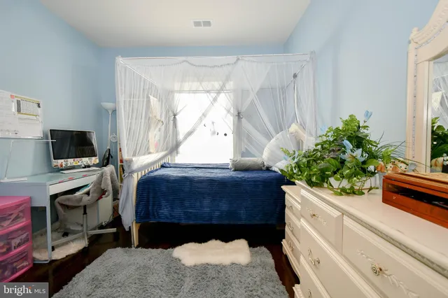 a room with a bed and a potted plant