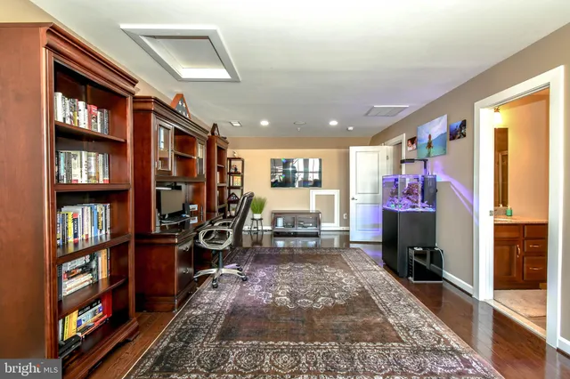 a living room with glass door and furniture