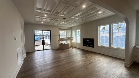 a view of an empty room with a fireplace and a window