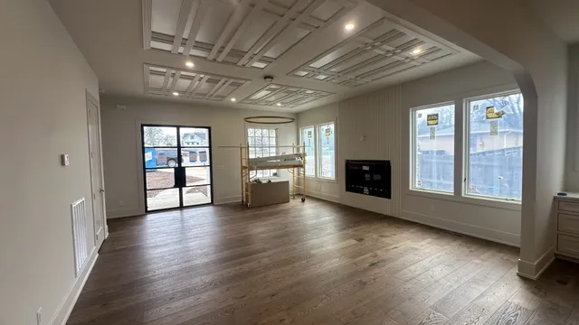 a view of an empty room with a fireplace and a window