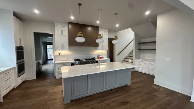 a large kitchen with a large counter top appliances and cabinets