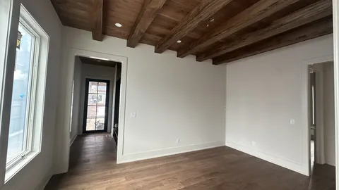 a view of hallway with wooden floor