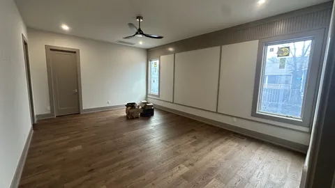 a view of a livingroom with wooden floor and window