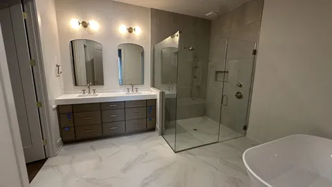 a large bathroom with a double vanity sink mirror and shower