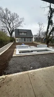a view of house with outdoor space and trees