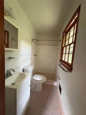 a white toilet sitting next to a bathroom sink