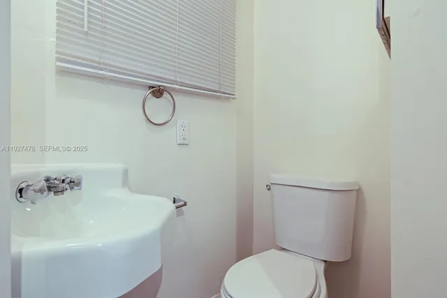 a bathroom with a toilet and a sink