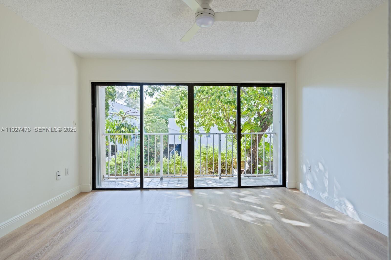 3028 Center Street, Unit 3028 Miami, FL 33133 - Photo 17 of 24 an empty room with wooden floor and windows