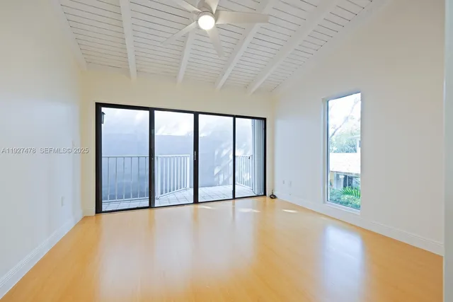 an empty room with windows and closet