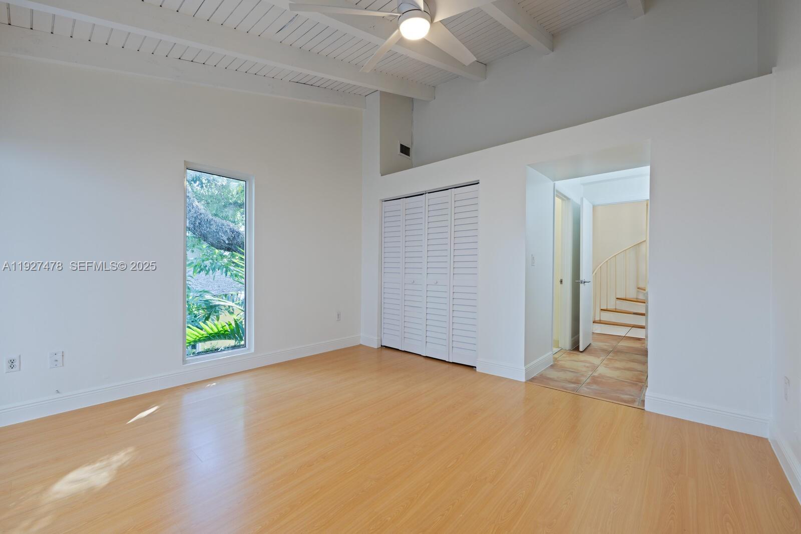 3028 Center Street, Unit 3028 Miami, FL 33133 - Photo 21 of 24 an empty room with windows and closet