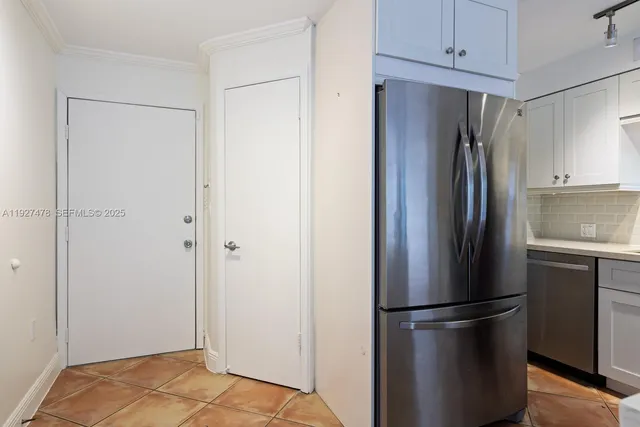 a metallic refrigerator freezer sitting in a kitchen