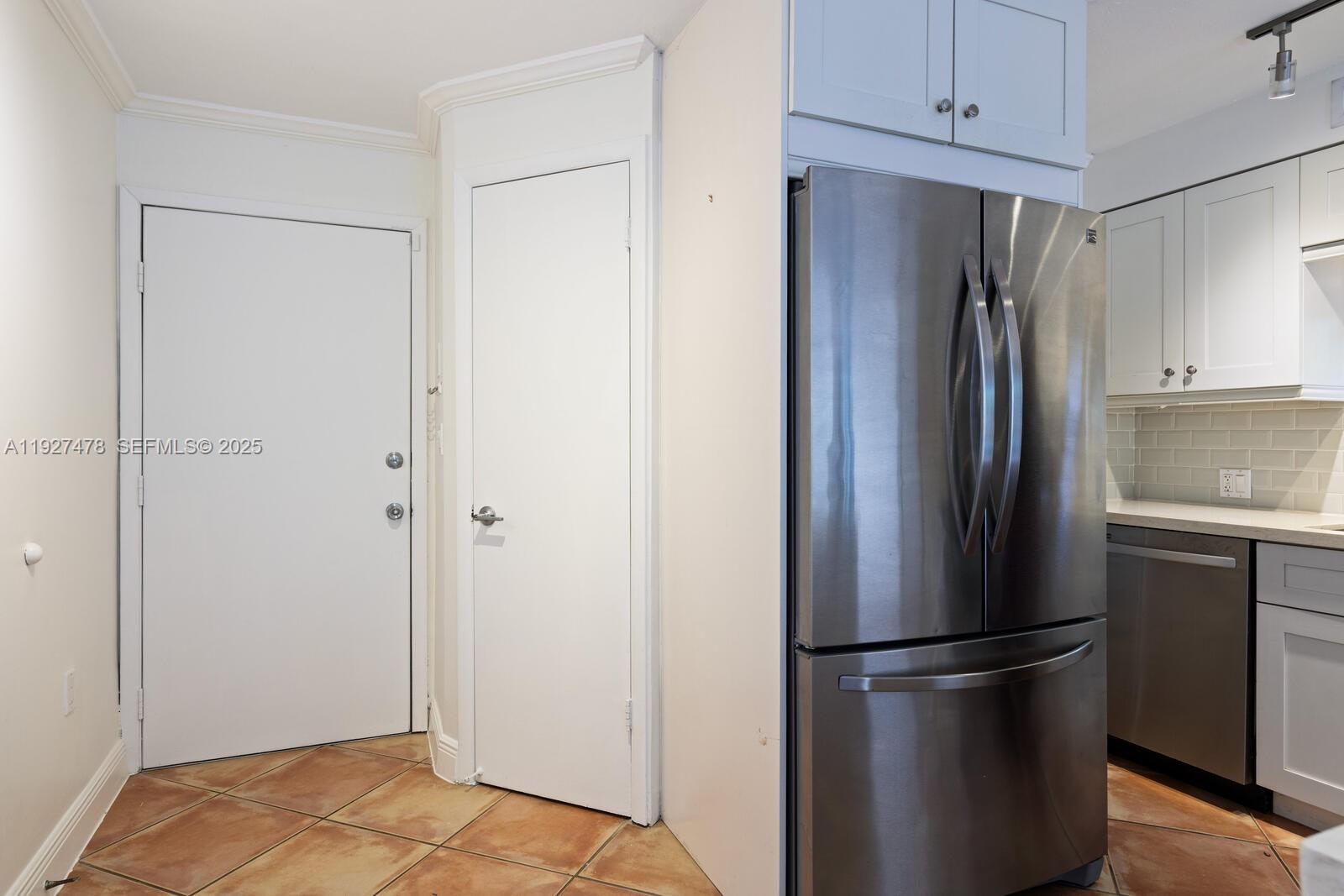 3028 Center Street, Unit 3028 Miami, FL 33133 - Photo 4 of 24 a metallic refrigerator freezer sitting in a kitchen