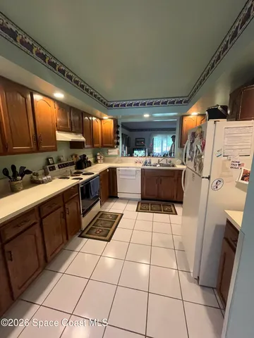 a kitchen with a sink a stove and cabinets