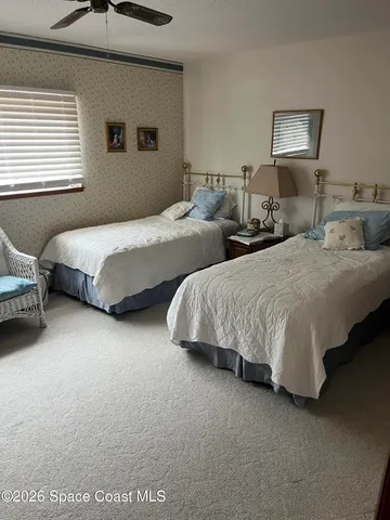 a bedroom with two beds and a couch