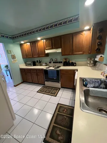 a kitchen with stainless steel appliances kitchen island granite countertop a sink counter space and cabinets