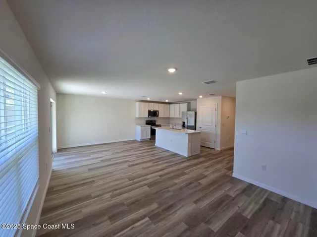 a view of kitchen living room with wooden floor