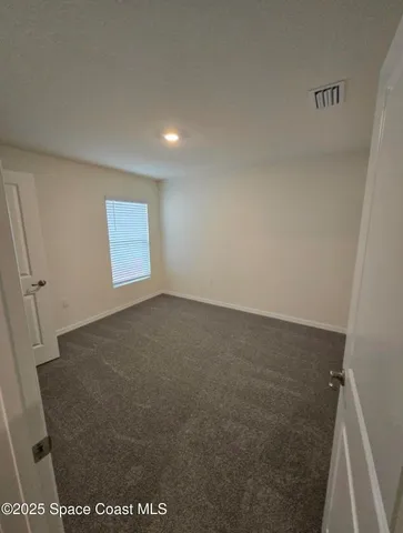 a bathroom with a granite countertop toilet a sink and mirror