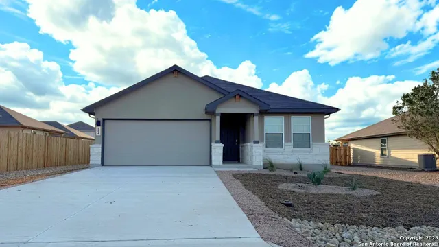 a front view of a house with garage