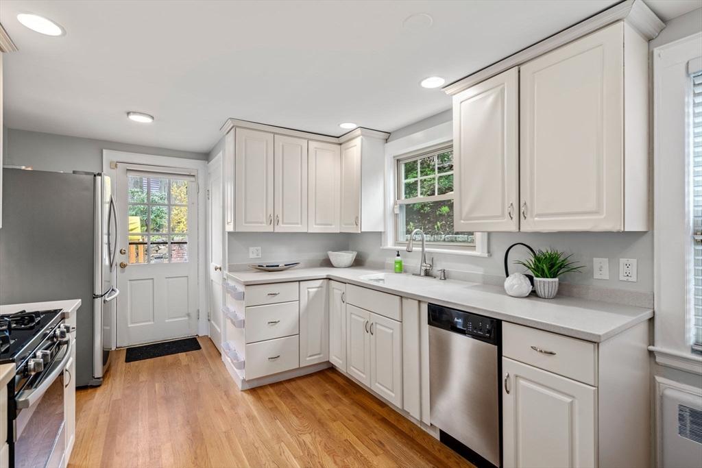 31 Northbourne Road Boston, MA 02130 - Photo 16 of 34 a kitchen with a white cabinets sink and stainless steel appliances
