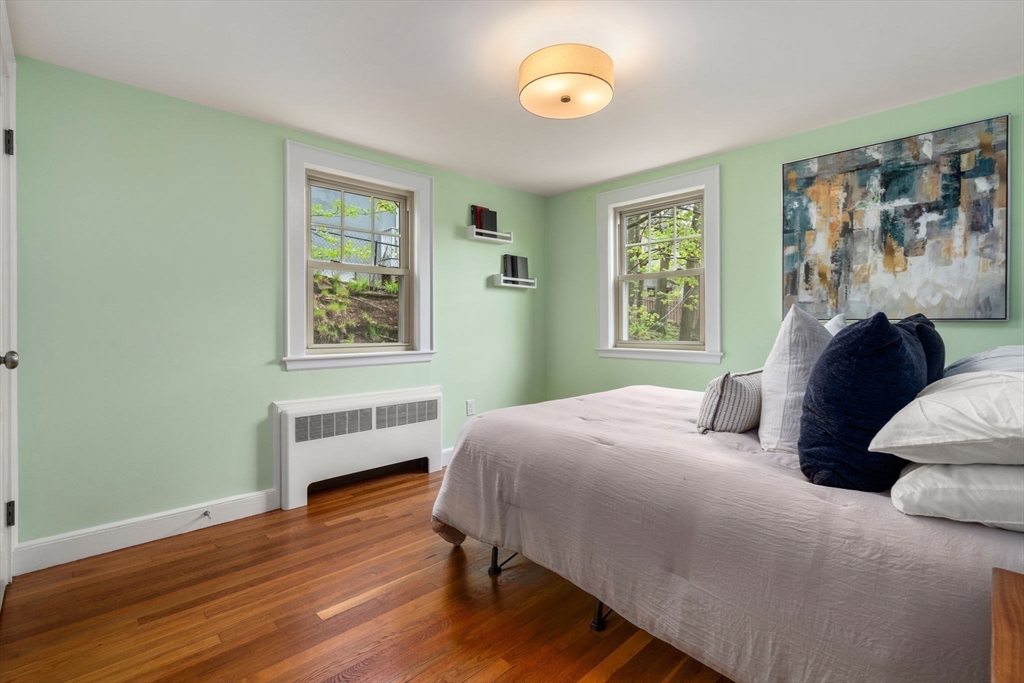 31 Northbourne Road Boston, MA 02130 - Photo 23 of 34 a bedroom with a bed and wooden floor