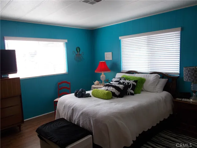 a bedroom with a bed dresser and a window