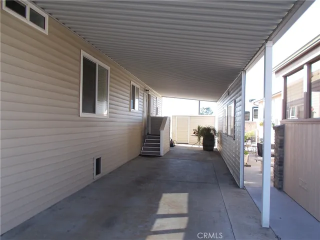 a view of a house with a barbeque and wooden floor