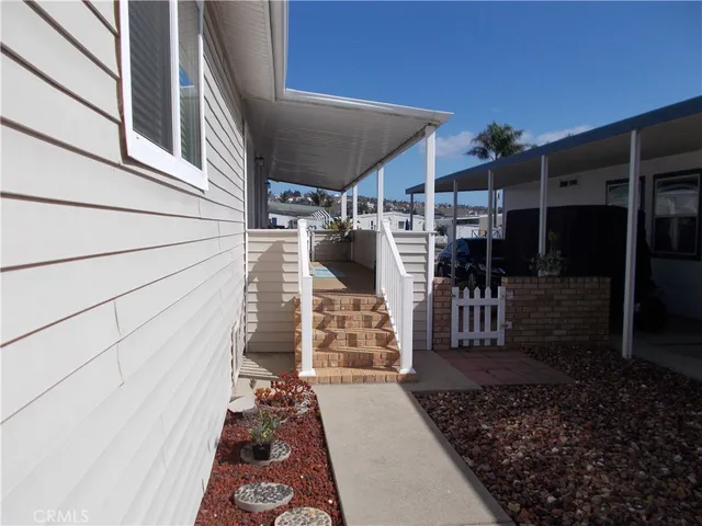 a view of a patio with table and chairs with wooden floor and fence