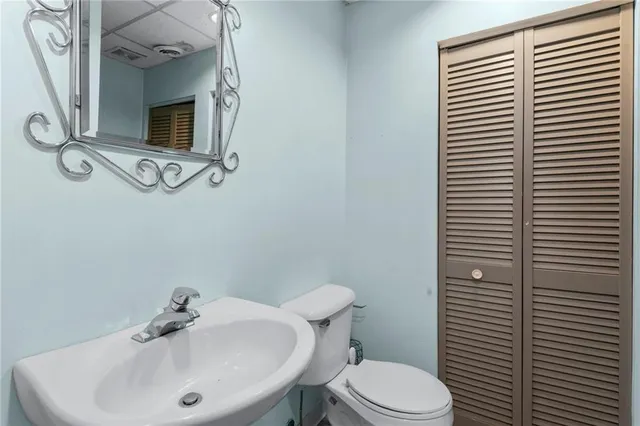 a bathroom with a sink a toilet and mirror