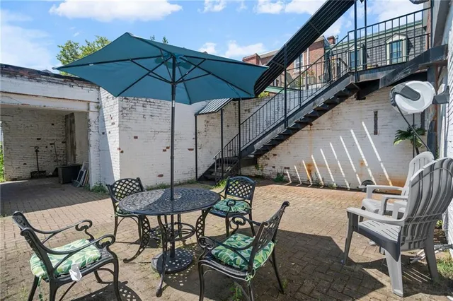 a backyard of a house with table and chairs