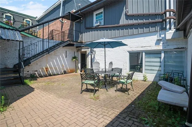 a view of a patio with table and chairs with wooden floor