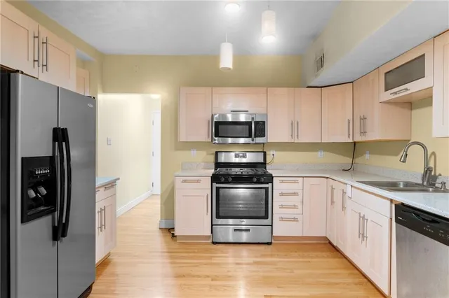 a kitchen with a sink stainless steel appliances and cabinets