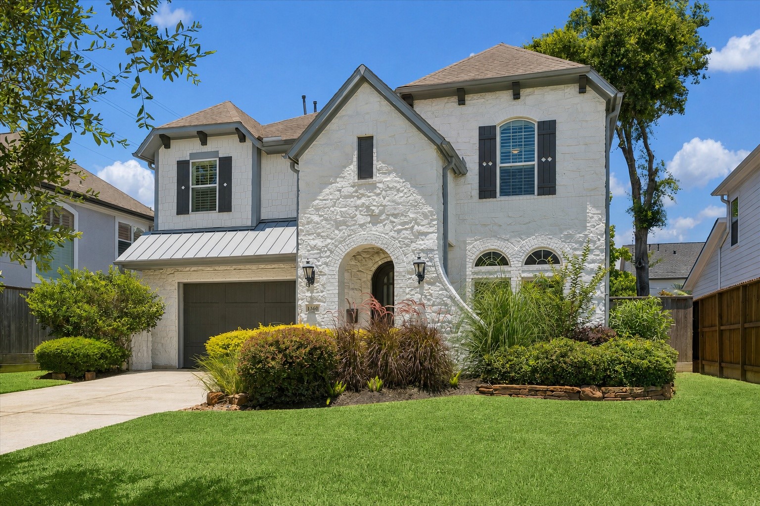 1360 Chippendale Road Houston, TX 77018 - Photo 1 of 34 Beautifully appointed Oak Forest residence thoughtfully designed for refined entertaining & everyday comfort. Charming curb appeal with a white painted stone exterior, covered front patio, arched black iron front door, and attractive landscaping creates a warm welcome. Fabulous location within walking distance of sought-after Oak Forest Elementary and Oak Forest Park.