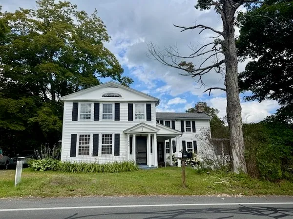 a front view of a house with a garden